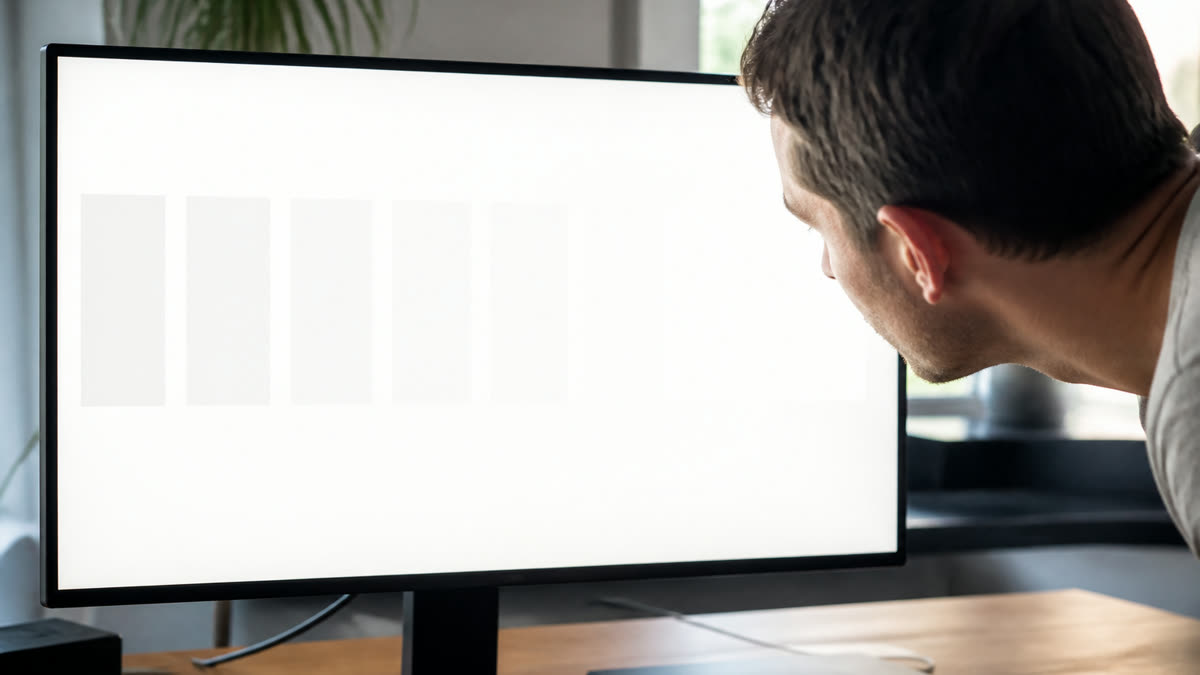 Near-white contrast test where pale gray steps merge into a clipped white field on a desktop monitor.