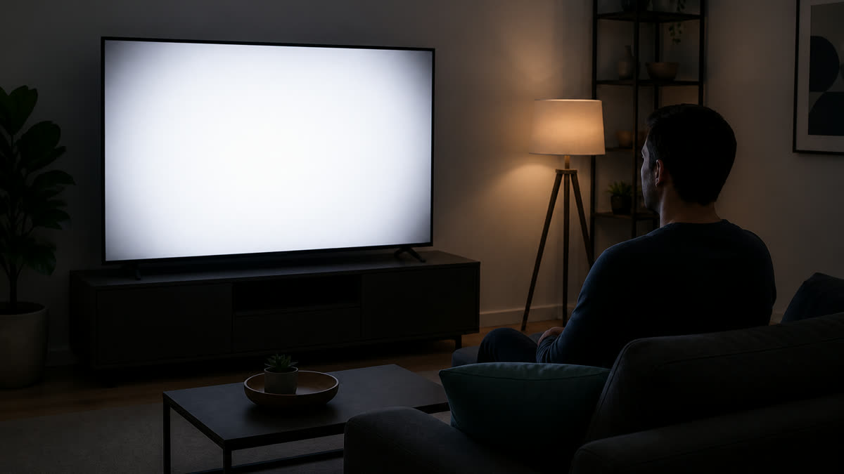White fullscreen TV test showing darker corners and a brighter center during a uniformity check.