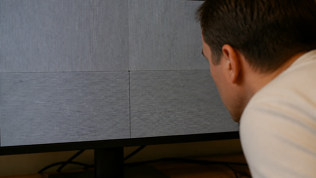 A desktop monitor showing a fine line test pattern that looks soft and mushy from wrong scaling.